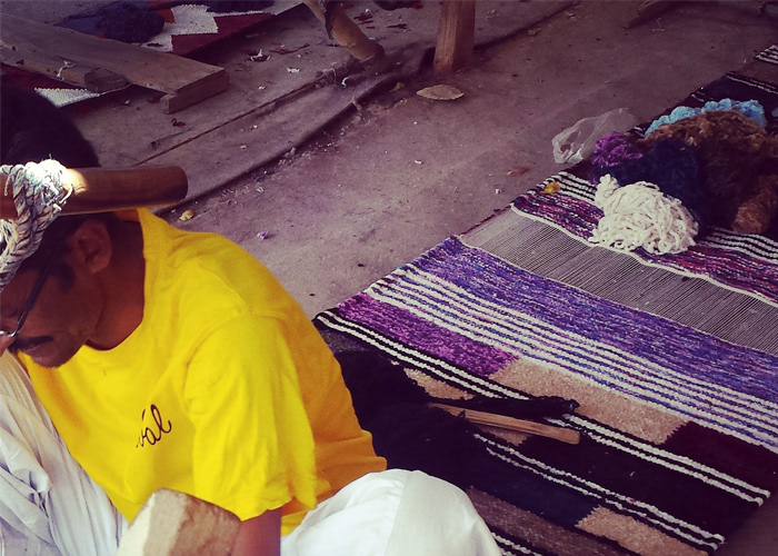 Cheval Rugs artisan working by hand at a floor loom