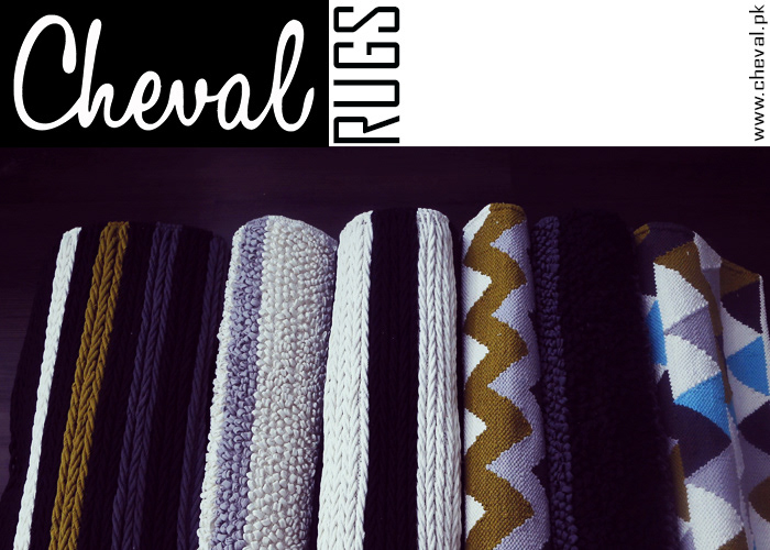 Cheval Rugs logo and website address above rolled rugs from the collection